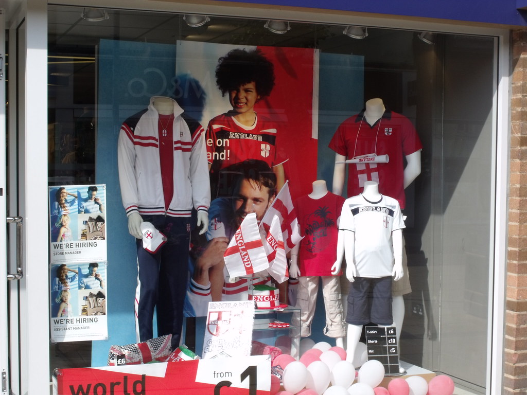 A retail store display in a high street shop, with products arranged on shelves under promotional signage.
